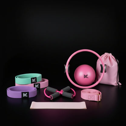 various pink fitness products including a ball, resistance bands, and a drawstring bag on a black background.