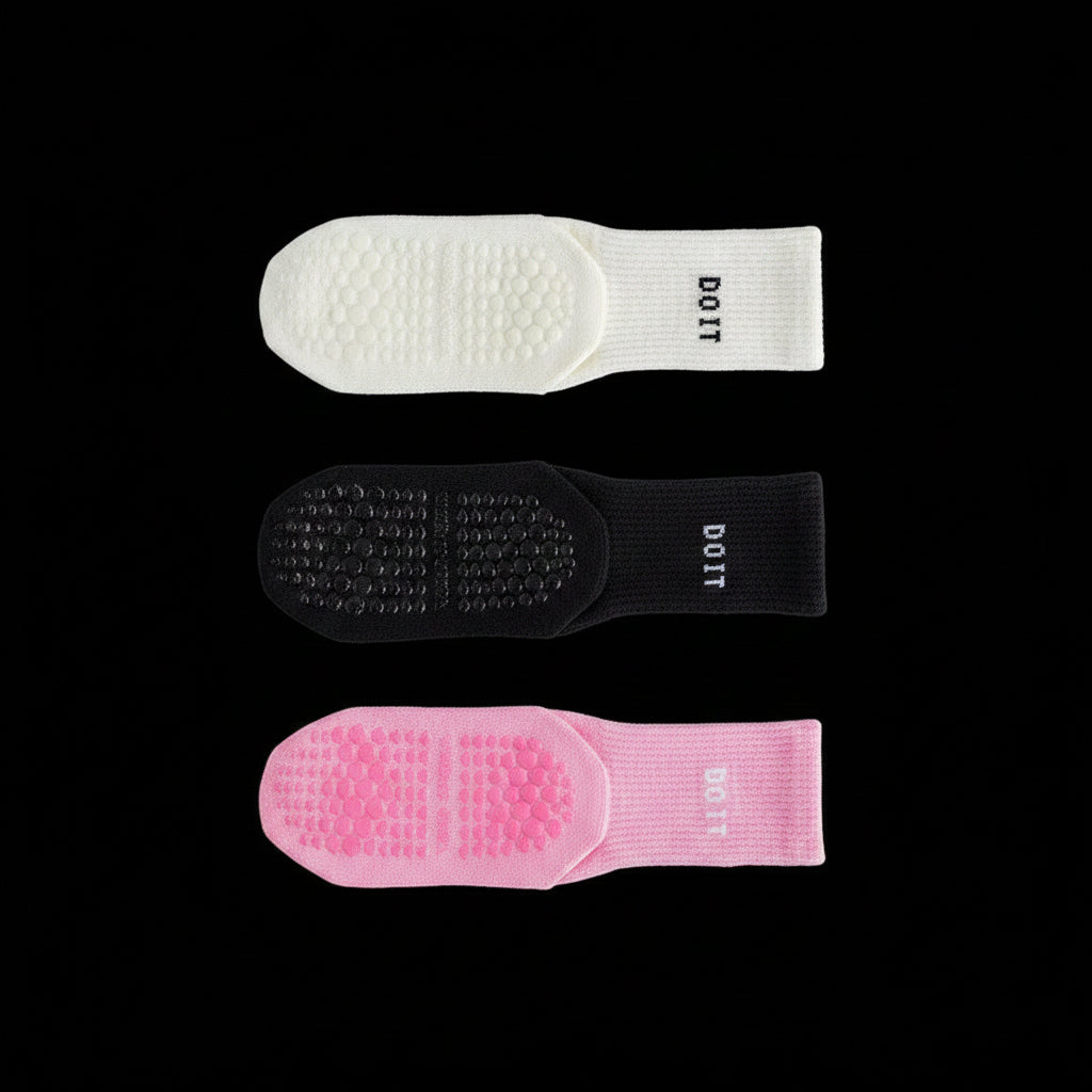 Three pairs of socks in white, black, and light pink on a black studio background with 'DOIT' branding.