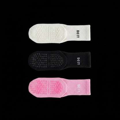 Three pairs of socks in white, black, and light pink on a black studio background with 'DOIT' branding.